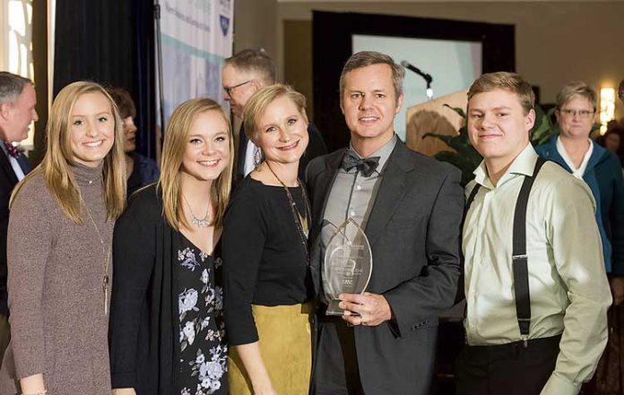 Above, holding the award for 2018 Outstanding Business Person of the Year from the Fayette County Chamber of Commerce is (center) Joe Domaleski, flanked by (L-R) daughters Tori and Alex, wife Mary Catherine and son Stephen. Photo/Roger Sibaja, Gobi Photography.