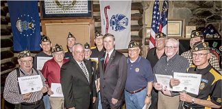 GDVS Commissioner Mike Roby (center, left) and state Sen. Marty Harbin (center, right) presented members of American Legion Post 105 with their Vietnam War Certificates of Honor. The Legionnaires received their certificates at a ceremony held at the “Log Cabin” in Fayetteville in February 2016. Photo/Submitted.