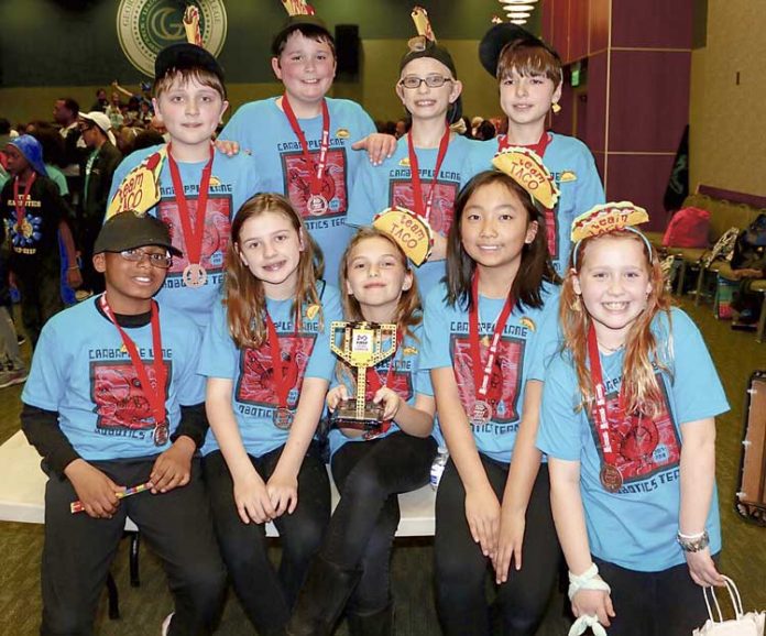 Members of team TACO show off the First Lego League state championship trophy they received for their innovative solution to filling water bottles at drinking fountains. Photo/Fayette School System.