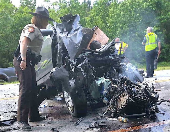 Law enforcement and emergency personnel investigate the aftermath of a two-vehicle collision Tuesday on Ga. Highway 85 in Fayetteville. Photographer Doug Fields said the wreck happened just south of Smith Auto Repair and Corvette Country. Photos/Doug Fields.