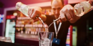 Barman pouring a cocktail. Photo/Shutterstock.