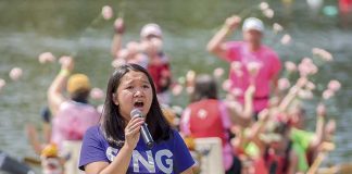 Anna Seville sings “You Lift Me Up” at the edge of the Lake McIntosh pier Saturday afternoon during festivities for the annual Rotary Club Dragon Boat Races. Photo/Markus Schwab Photography.