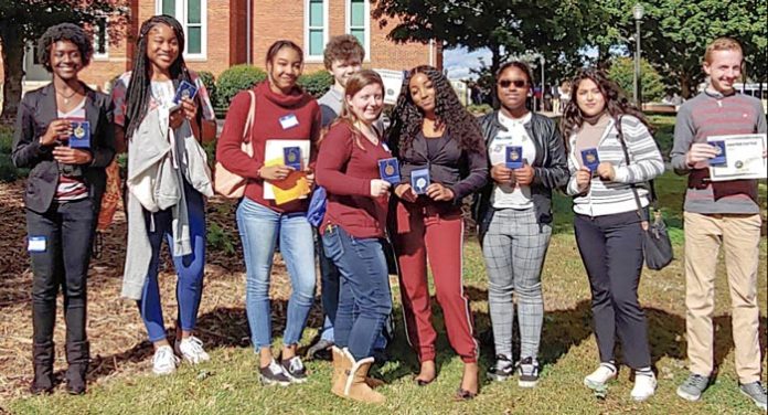 Foreign language students at Sandy Creek High display award medals from poetry contest. (L-R): Lydia Jenkins, Madalya Hardnett, Andrea Huisso, Will Lockridge, Anna Pate, Aiyanna Gulley, Stacy Gonzalez, and Jonathan McClenny. Photo/Submitted.