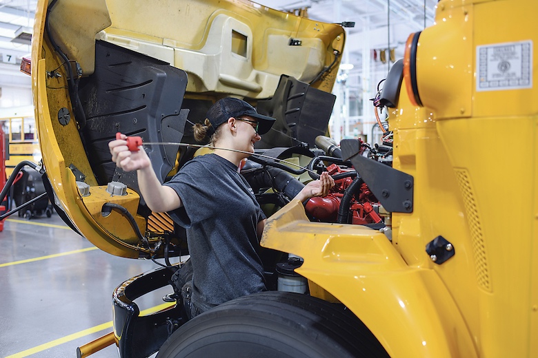 Lindsey Crook performs routine maintenance check on one of the school system’s buses. Photo/Fayette County School System.