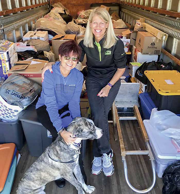 Kathy Gloer and friend Sandi Donaldson help to load a trailer full of relief supplies for hurricane victims in the Florida panhandle. Photo/Hearts with Hope Facebook page.