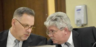 Peachtree City Manager Jon Rorie (R) confers with City Attorney Ted Meeker at a City Council meeting. Photo/Cal Beverly.