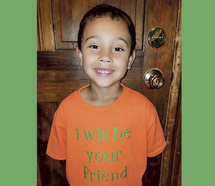 Blake Rajahn models his T-shirt offer on his mom’s Facebook page.