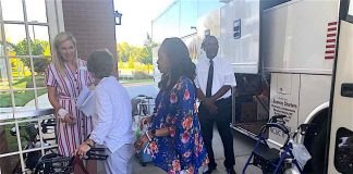 Logan Johnston (L), executive director of Heartis Fayetteville, welcomes residents and staff of Portside at Grande Dunes from South Carolina. Photo/Joyce Beverly.