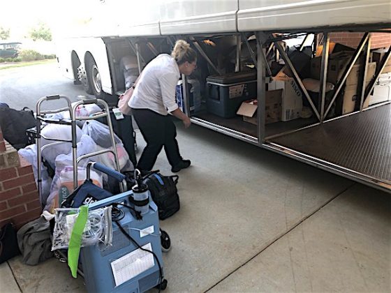 Portside Grand Dunes staff member helps unload well-organized bundles of clothing and more for residents who are temporarily sheltering at Heartis Fayetteville. Photo / Joyce Beverly.