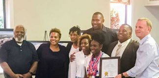 Flat Rock Middle School athlete was honored Sept. 5 by the Tyrone Town Council. Pictured with Noelle, in front, and her coach Rex Willis, second from right, and Mayor Eric Dial, at right, were members of her family. Photo/Ben Nelms.