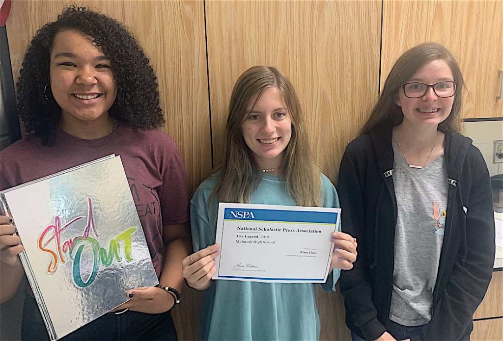 2020 Legend editors Jaylen Smith (12), with a copy of the 2019 book; Rachel Edge (12), holding the NSPA award; and Natalie Spellman (10). Photo by Landon Wilde.