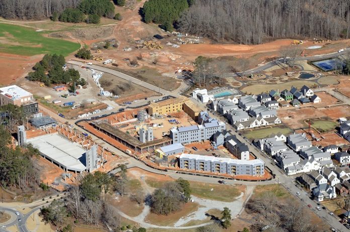 A drone shot of the current development at Pinewood Forest shows, at center and left center, the three large buildings that will house 40,000 sq. ft. of retail and 263 apartments when completed in late 2020. Photo/Pinewood Forest.