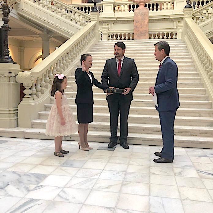 Six-year-old Margrit and husband Karl watch as Marie Broder is sworn-in as Griffin Judicial Circuit District Attorney by Gov. Brian Kemp in a June 3 ceremony. Photo/Submitted.