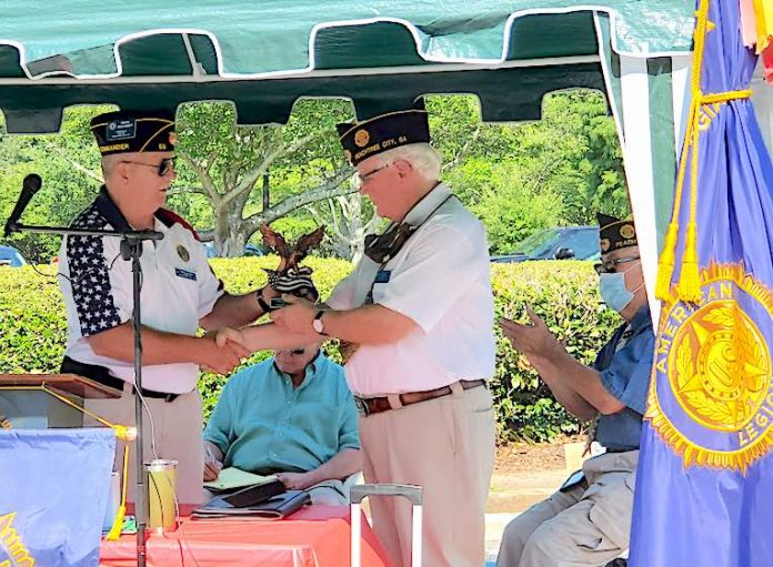  New Post 50 Commander Mark Gelhardt presents an eagle statue to the outgoing Commander Leigh Blood. Photo/Submitted.