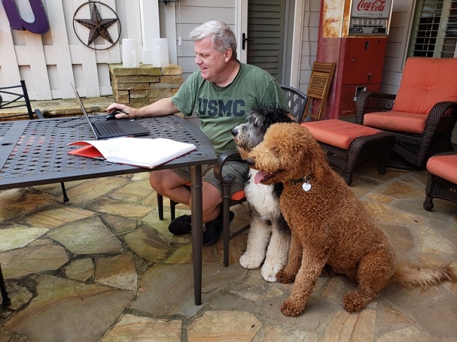 Testing positive for Covid-19 has not stopped Fayette County Administrator Steve Rapson from doing his job. Rapson continued working from home on Tuesday during quarantine, with the help of his two rescue dogs. Photo/Kristi Rapson.