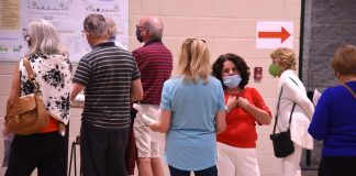 Peachtree City Mayor Vanessa Fleisch (in red facing camera) hears from a resident during the LCI Open House Oct. 22 at Kedron Fieldhouse. Photo/Cal Beverly.