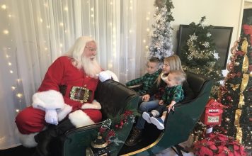 Fayetteville residents Parker Bryan, 5, (at left), Ali Bryan, 9, and J.T. Bryan, 2, were at Trilith in Fayetteville on Dec. 5 to spend time with Santa. Photo/Ben Nelms.