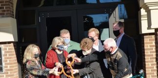 Cutting the ribbon at the new Tyrone Municipal Complex on Dec. 10 were, from left, front row, council members Melissa Hill, Gloria Furr, Linda Howard and Billy Campbell; and from left in rear, Town Manager Brandon Perkins, Mayor Eric Dial and Fayette Chamber of Commerce CEO Colin Martin. Photo/Ben Nelms.