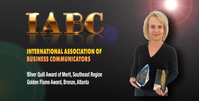 Fayette County School System Public Information Officer Melinda Berry-Dreisbach holds the IABC award. Photo/Fayette County School System.