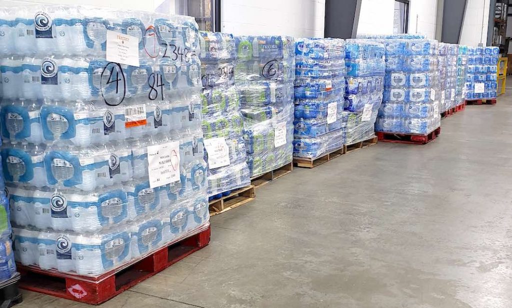 Pallets of drinking water await loading for ship to texas from the Midwest Food Bank warehouse in Peachtree City. Photo/Midwest Food Bank.