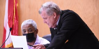 Fayette County Commissioner Charles Rousseau (L) and County Administrator Steve Rapson discuss agenda item before the regular meeting May 13. Photo/Cal Beverly.