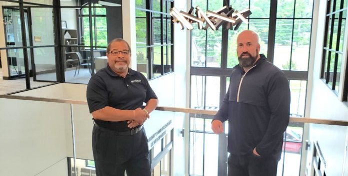 Fayetteville Mayor Ed Johnson and City Manager Ray Gibson stand in the atrium of the new City Hall. Photo/City of Fayetteville.