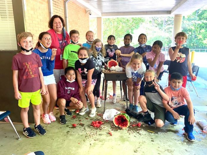 Shawn Agur’s 3rd grade class enjoys their science experiment and snacks on some watermelon, too. Photo/Fayette County School System.