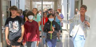 Principal Deb Troutman leads current and future Booth Middle School into their new school during a tour last week. Photo/Fayette County School System.