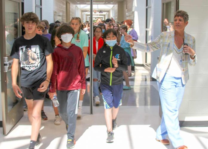 Principal Deb Troutman leads current and future Booth Middle School into their new school during a tour last week. Photo/Fayette County School System.