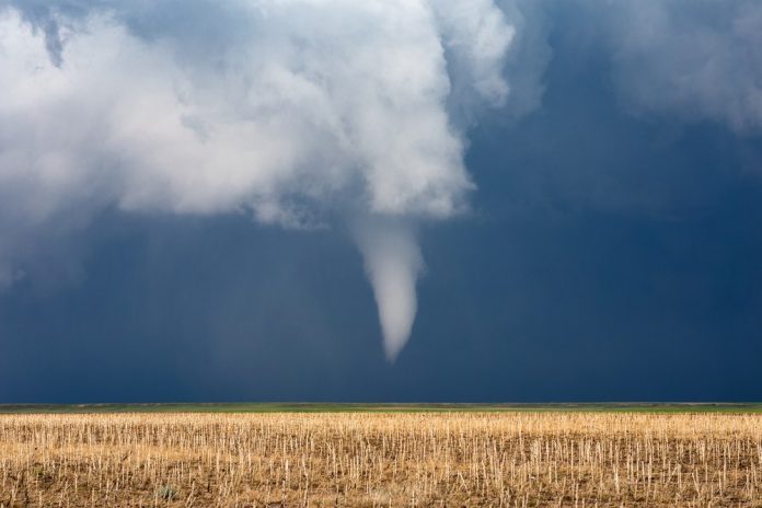 Funnel cloud over field. Shutterstock image.