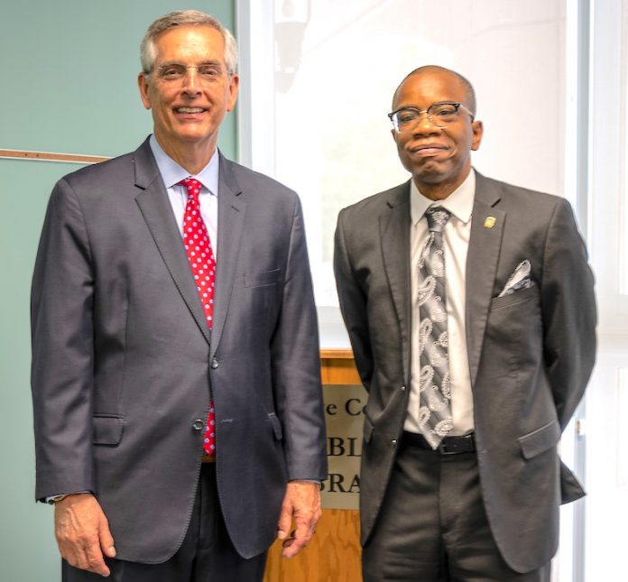 Secretary of State Brad Raffensperger (L) meets with Brian Hill, director of elections and voter registration for Fayette County. Photo/Fayette County.