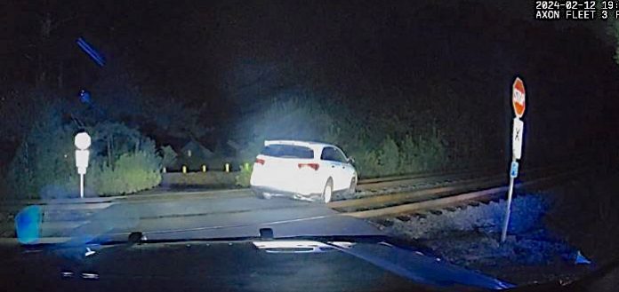 Police dash cam photo of a car parked on railroad tracks. Photo/Peachtree City Police Department.