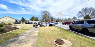 Officers compare notes after chase and arrest of carjacking juvenile. Photo/Fayette County Sheriff's Office