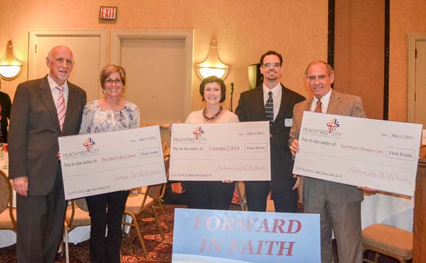 Peachtree City SDA Church presents checks to loc...
